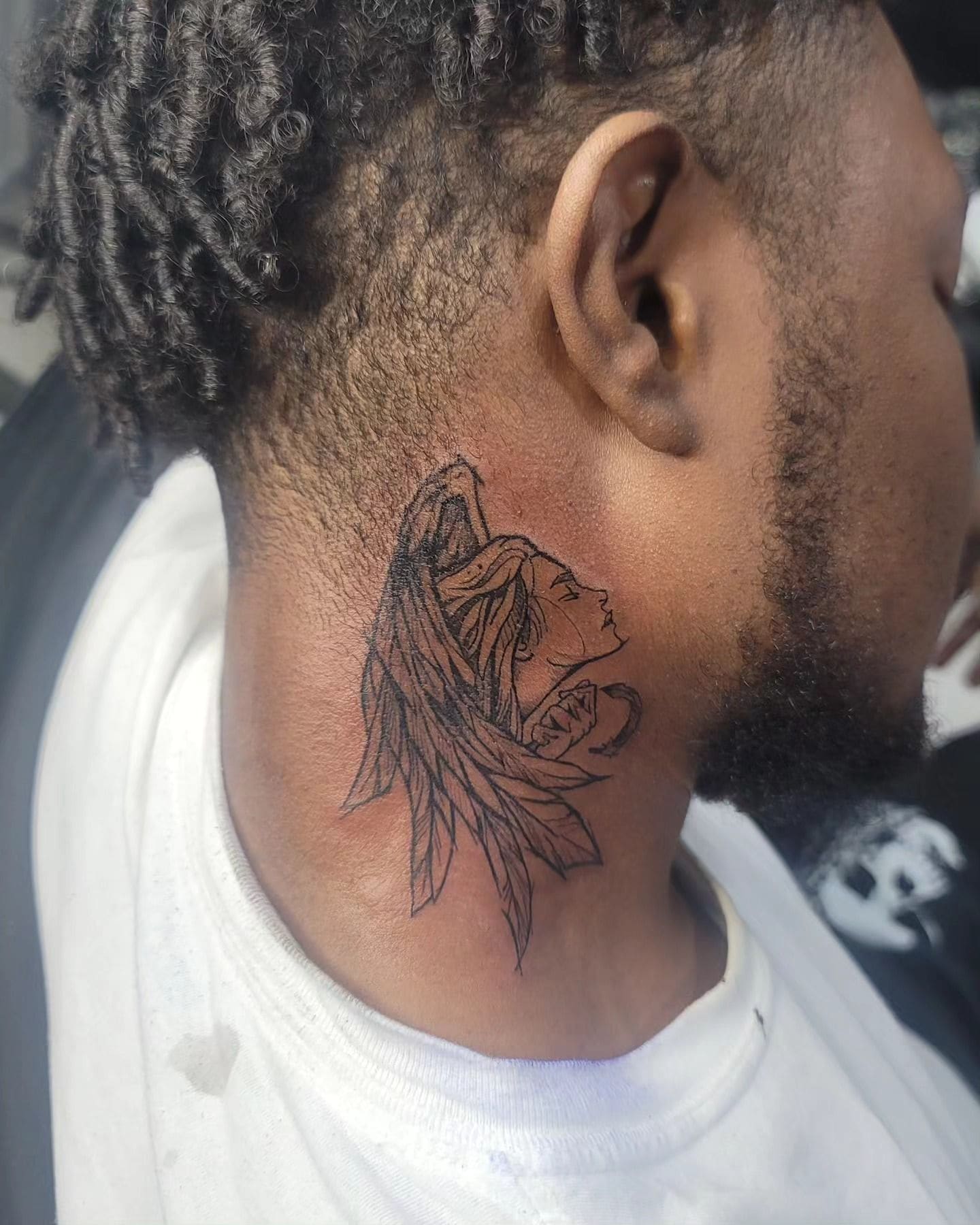 Black and grey Flower and bird tattoo on the neck, by Soulraven Studios in Kingston, Jamaica