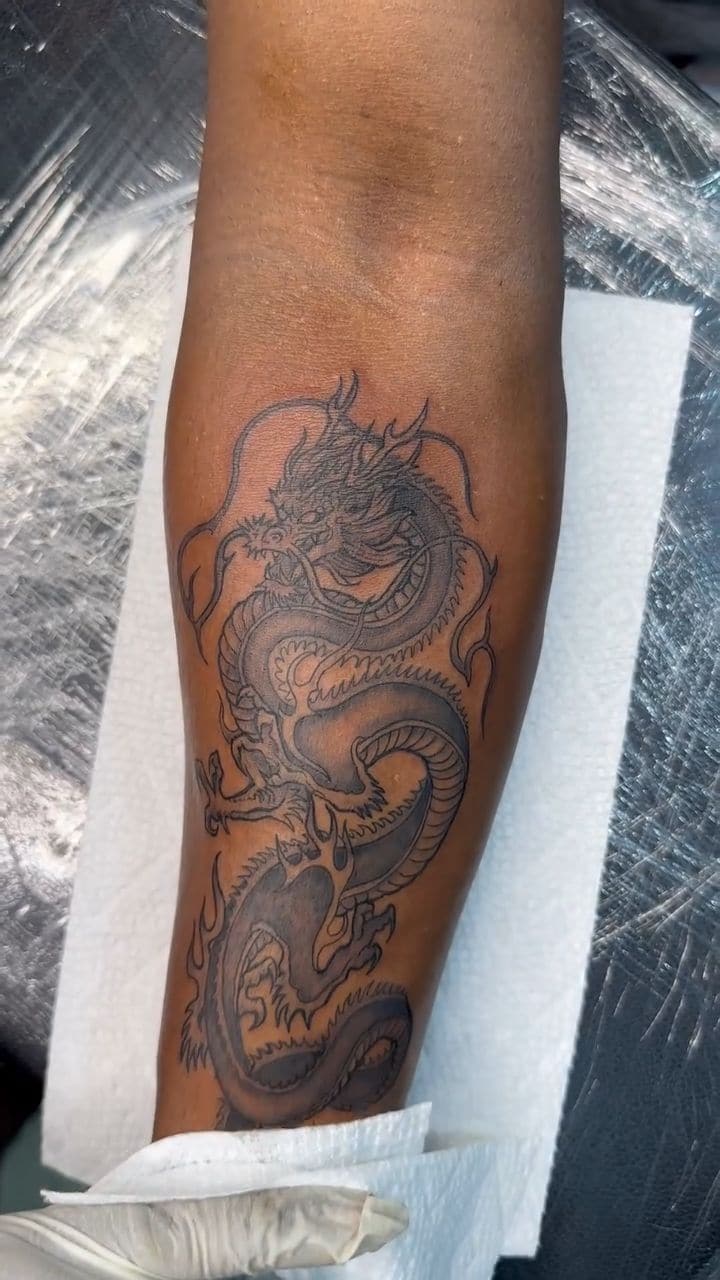 Black and grey Dragon tattoo on the forearm, by Soulraven Studios in Kingston, Jamaica