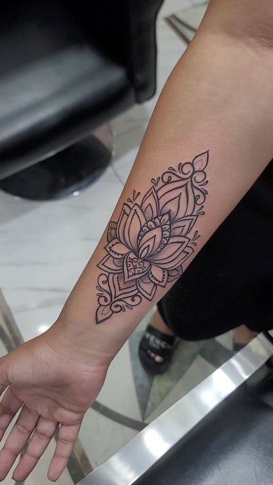 Black and grey Lotus mandala tattoo on the forearm, by Soulraven Studios in Kingston, Jamaica