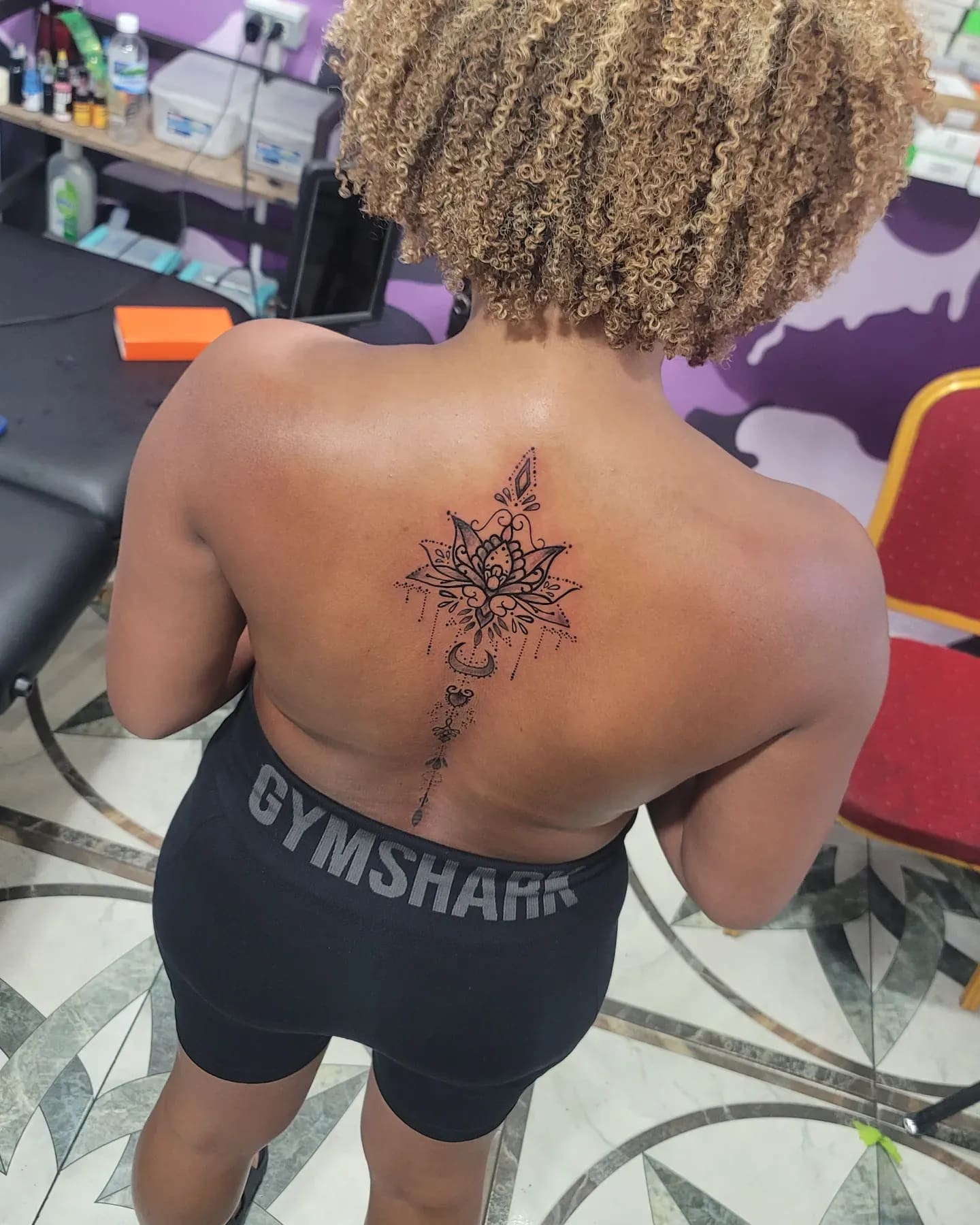 Black and grey Ornamental mandala tattoo on the spine, by Soulraven Studios in Kingston, Jamaica