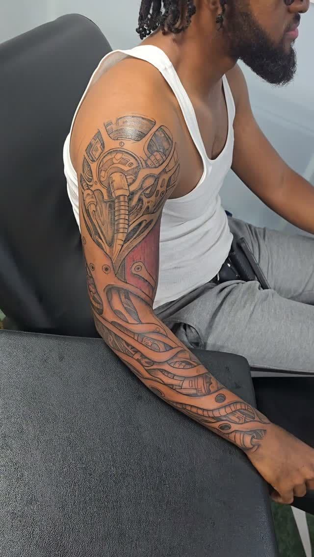 Black and grey Biomechanical sleeve tattoo on the full arm, by Soulraven Studios in Kingston, Jamaica