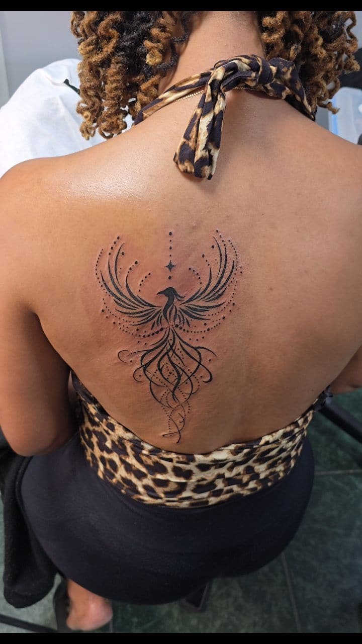 Black and grey Ornamental phoenix tattoo on the upper back, by Soulraven Studios in Kingston, Jamaica