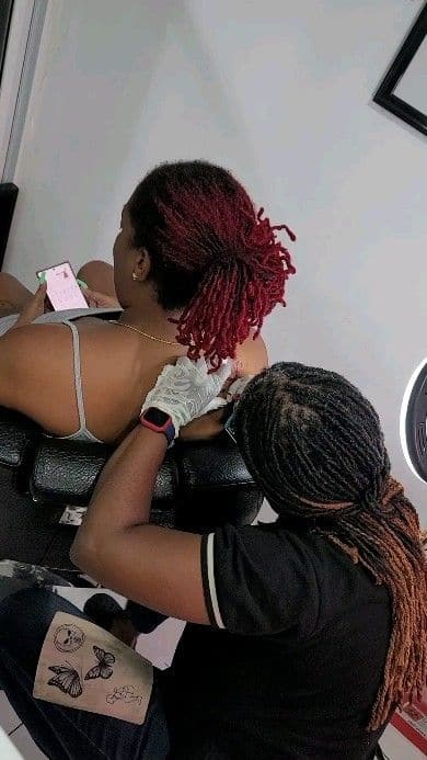 A Soulraven apprentice tattooing a client under the artist’s eye