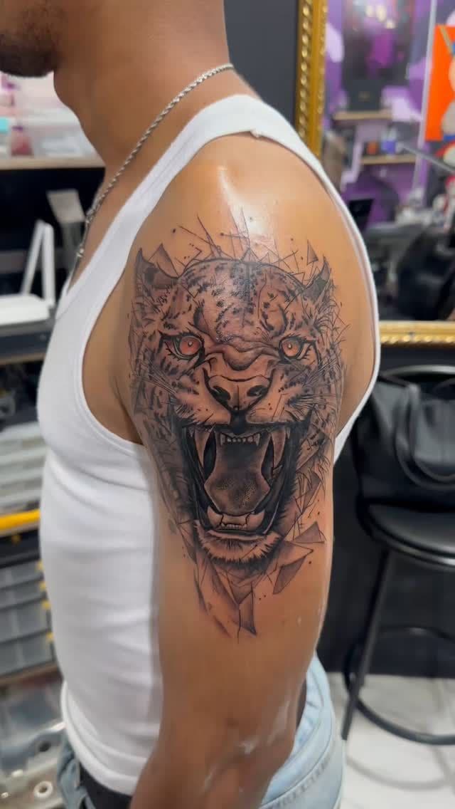 Black and grey Roaring tiger portrait tattoo on the shoulder, by Soulraven Studios in Kingston, Jamaica