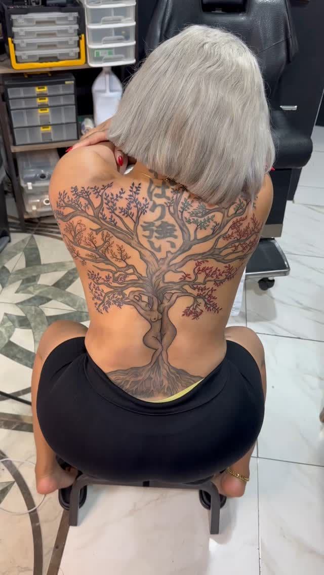 Black and grey with colour Tree of life with blossoms tattoo on the full back, by Soulraven Studios in Kingston, Jamaica