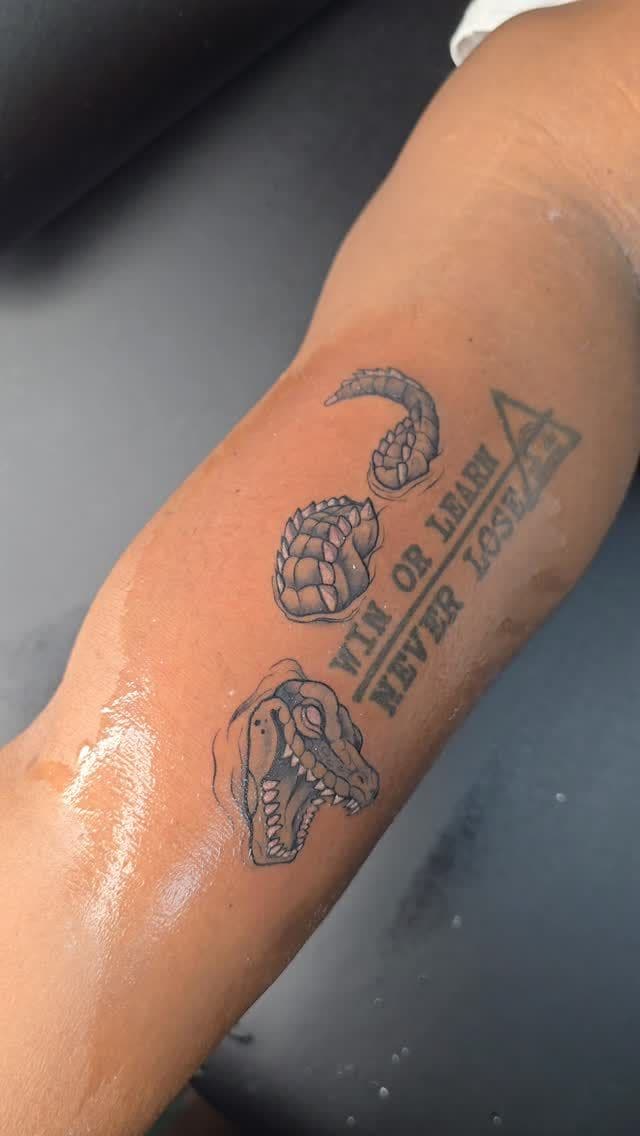 Black and grey “Win or learn, never lose” with crocodile tattoo on the forearm, by Soulraven Studios in Kingston, Jamaica